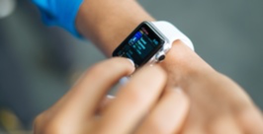 Someone touching the screen of his/her smartwatch